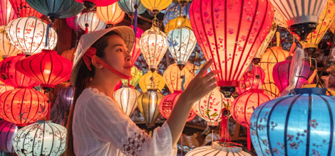 A woman exploring a display of colorful lanterns